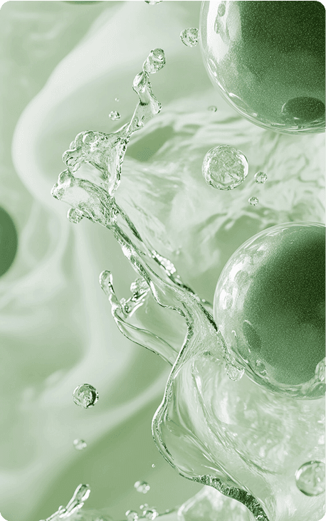 Green spherical objects surrounded by splashes of water and a soft blurred green background.